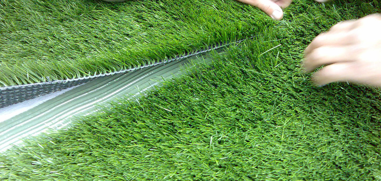 Creating an artificial turf seam.