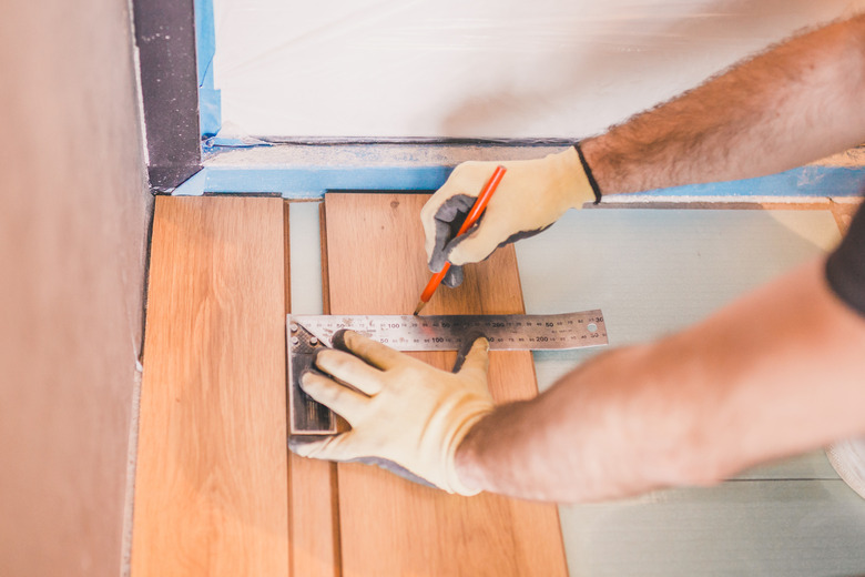 Master marks the laminate board for the cut