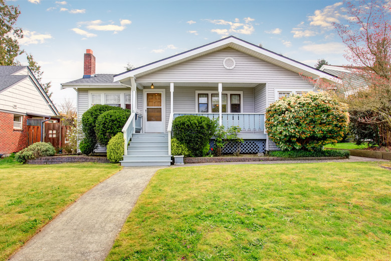 Beige siding house exterior with covered porch.