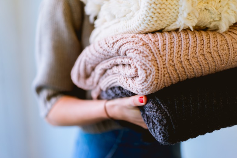 folded sweaters and blankets