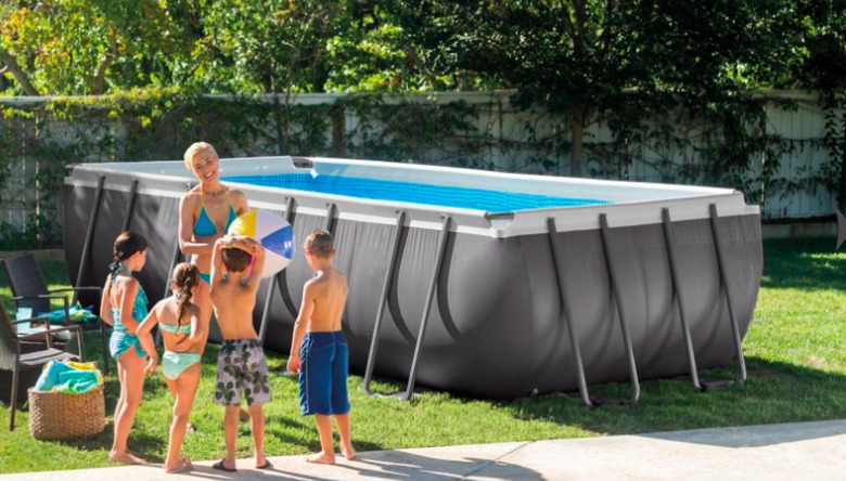 Family playing near above-ground swimming pool