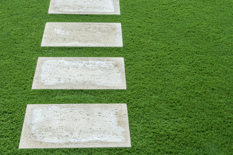 Stepping stones in lush green lawn