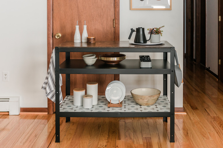 ikea hack featuring IKEA Bror Work bench turned into a kitchen island with plates and vessels on it