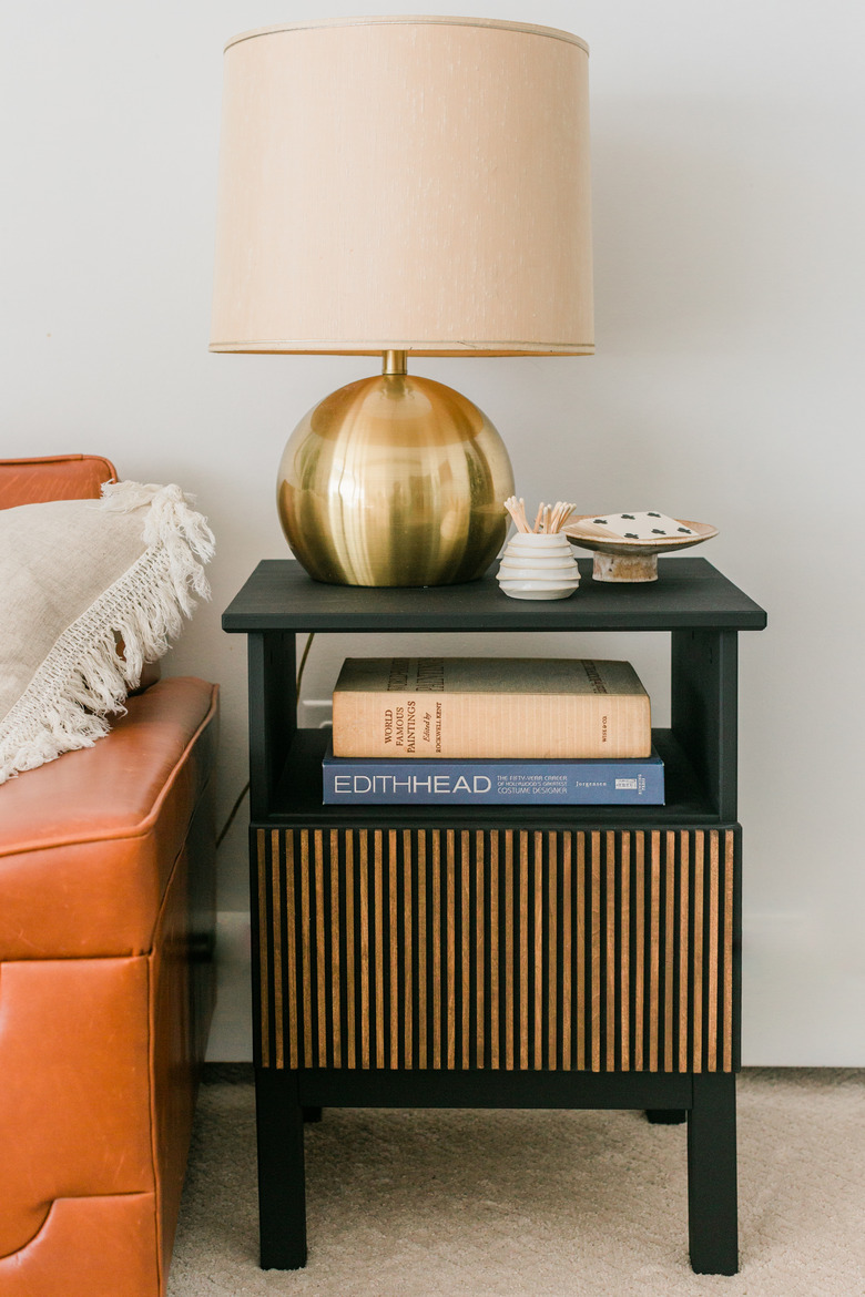 ikea hack of IKEA Tarva Nightstand upgraded with black paint and dowel rods