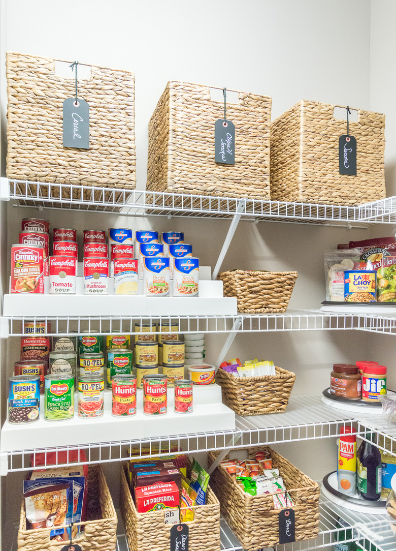 organized small pantry closet  with woven bins