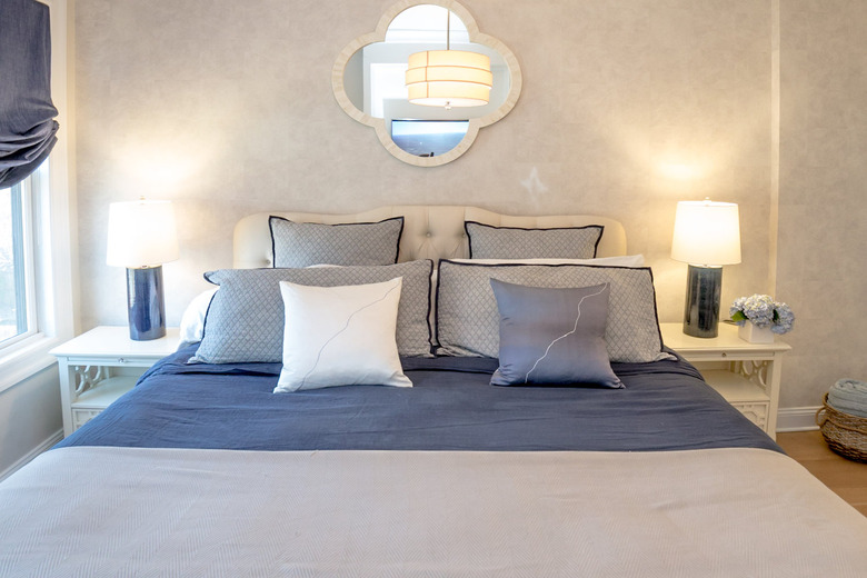 blue and white bedding featuring throw pillows