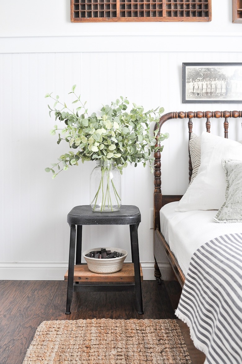 white farmhouse guest bedroom idea with vase full of eucalyptus