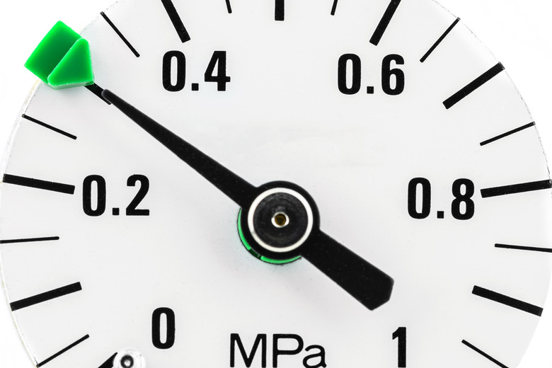 A macro photo of a pressure gauge scale to 1 Mpa showing a pressure of 0.3 Mpa, isolated on a white background.