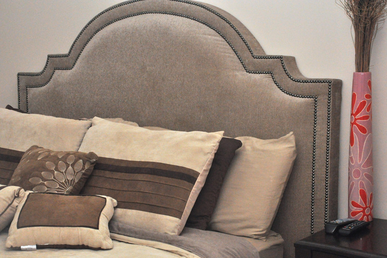 Bed with decorative headboard.