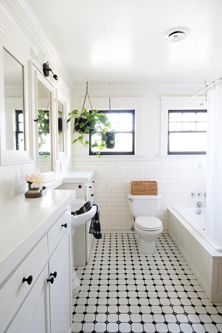 White walled bathroom with white-black tiled floor