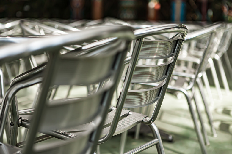 Aluminum  chairs and tables in outdoor cafe.