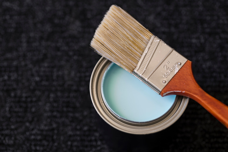 Close-Up Of Paintbrush On Paint Can At Table