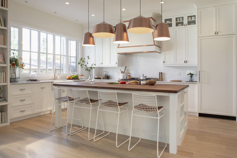 White home showcase interior kitchen with copper pendant lights