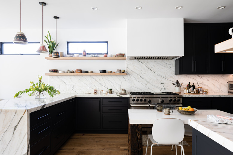 large kitchen with veined marble countertops and backsplash