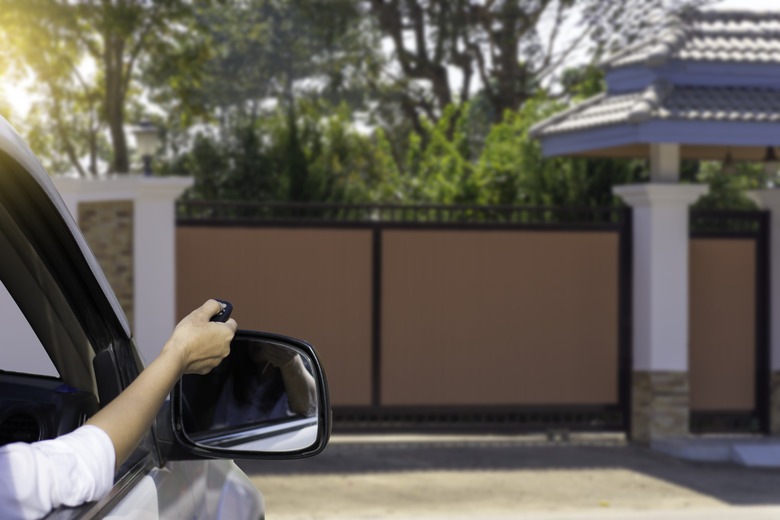 Opening electric gate from car via remote control.