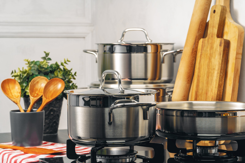 Clean saucepans on gas stove in kitchen.