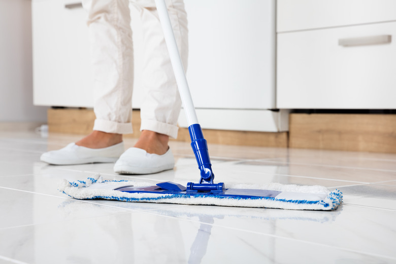 Woman Mopping The Floor In Kitchen