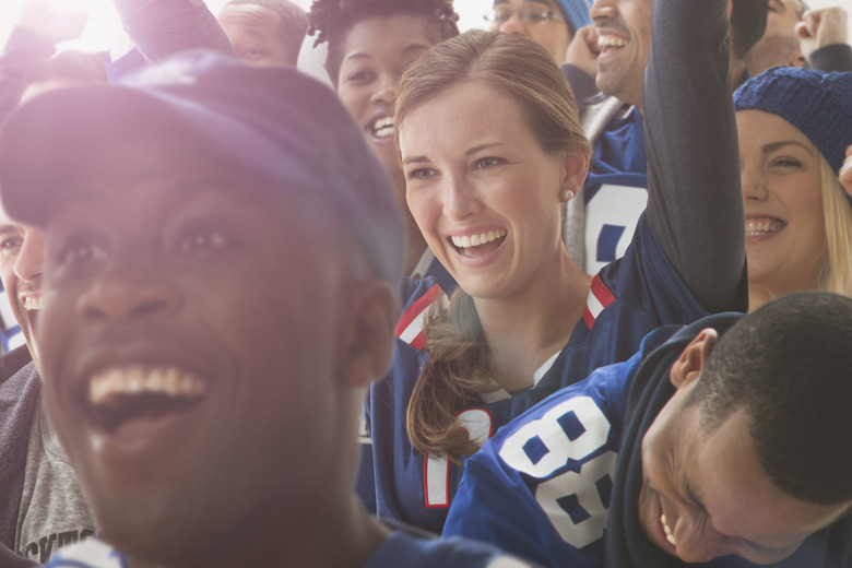 Fans cheering at American football game.