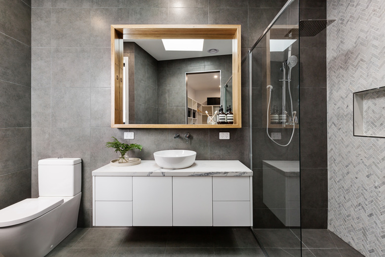 Modern grey designer bathroom with herringbone shower tiling