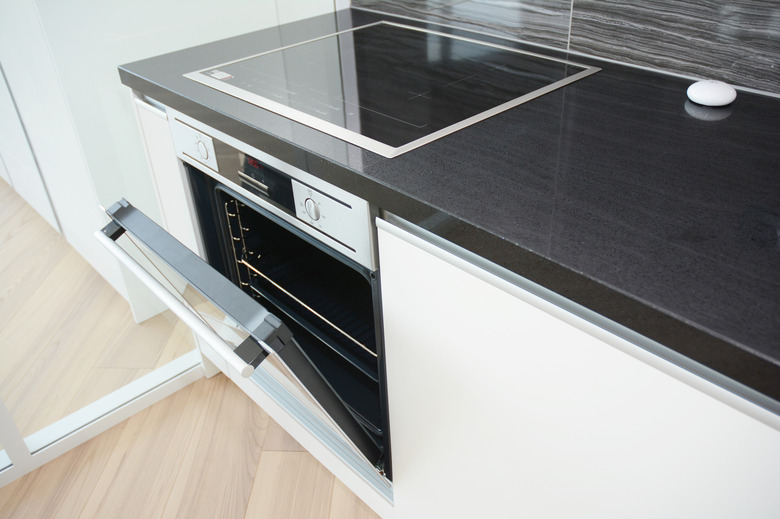 Modern kitchen interior with black and white electric oven, electric stove.