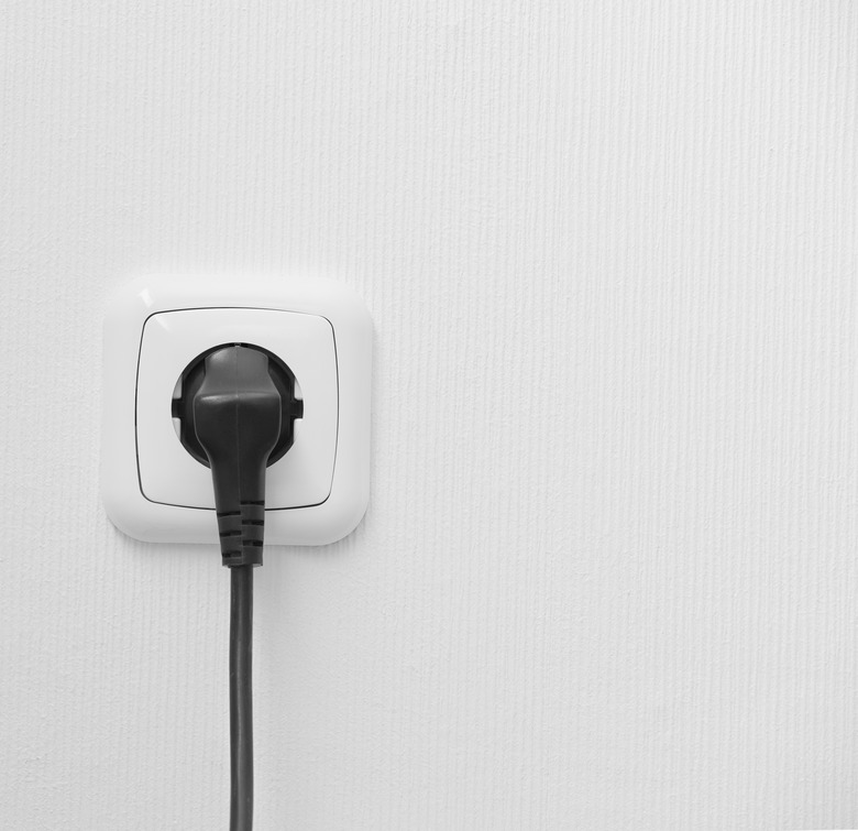 brand new outlet on a white wall with plug