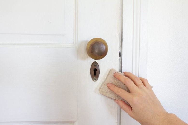 Hand sanding white door