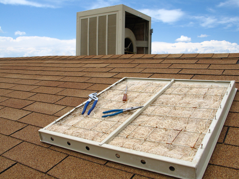 Swamp Cooler Maintenance on Reddish Shingled Roof