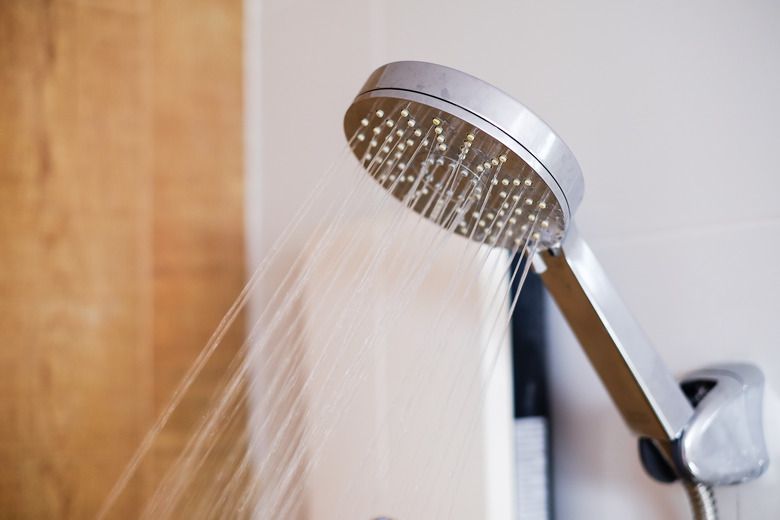 Shower cabin in a bathroom. Water stream flowing in modern bathroom.