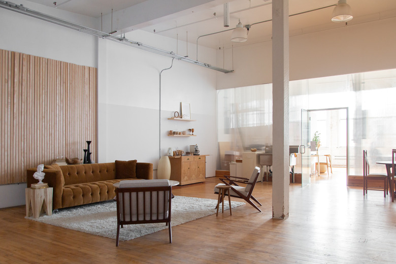 open loft living space with wood floors, tall ceilings