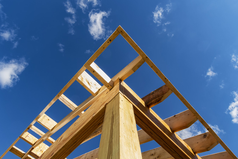 Looking up the rough framing of a residential addition’s roof