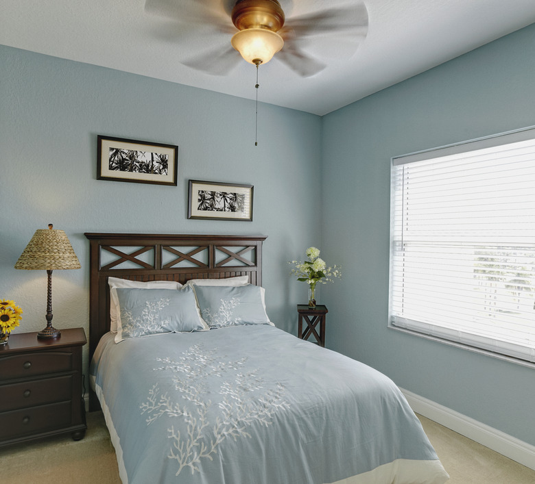 Ceiling fan over bed in bedroom.