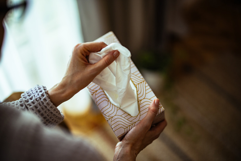 An Anonymous Woman Taking Paper Tissue Out Of Box