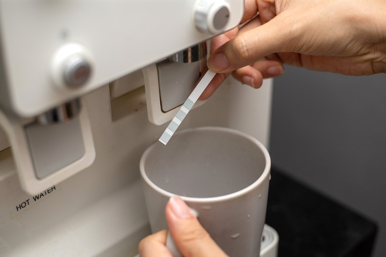 Checking the quality of tap water with a water test kit.