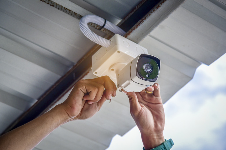 Technician installing CCTV camera for security