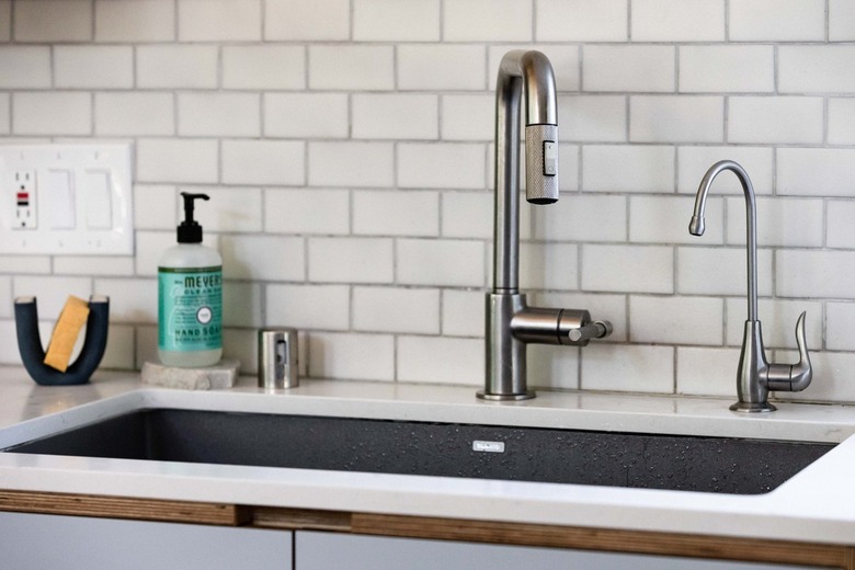 Kitchen sink with subway tile backsplash