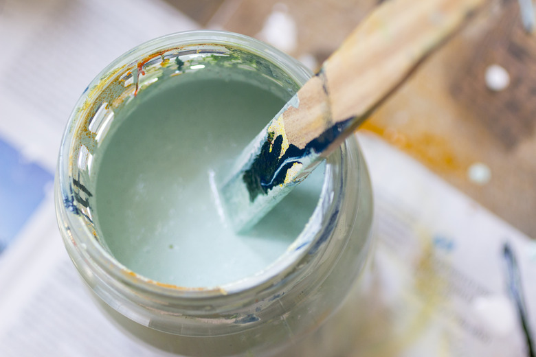 Stirring lightgreen paint.