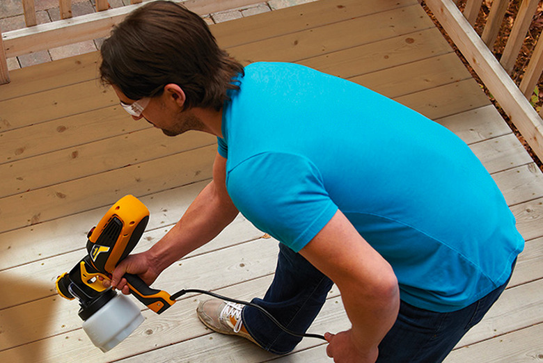 Man spraying a deck.