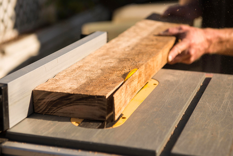 Cutting hardwood with a table saw.