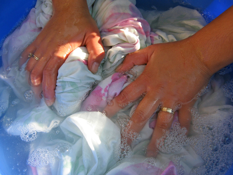 Woman hands washing clothes.