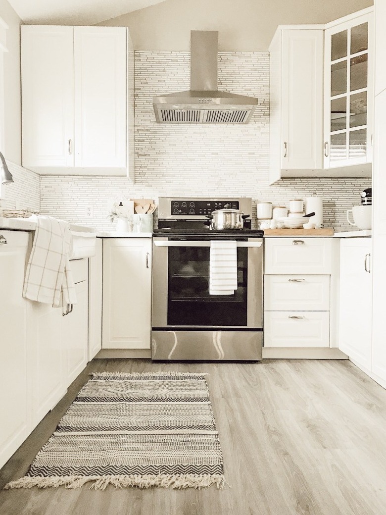 IKEA countertops in kitchen with white quartz and small subway tile backsplash