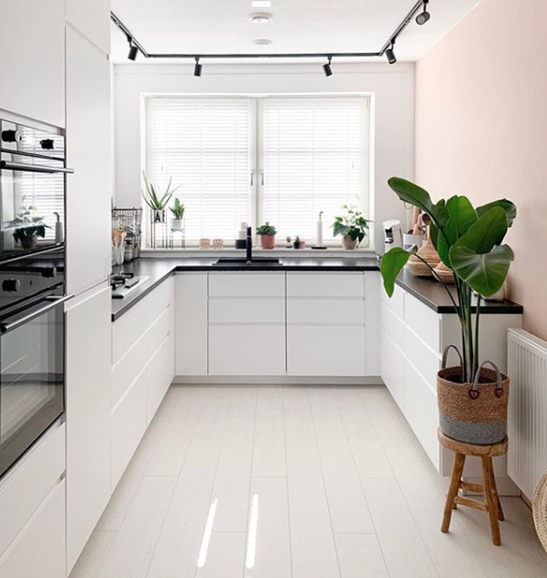 black laminate IKEA countertops in kitchen with white cabinets