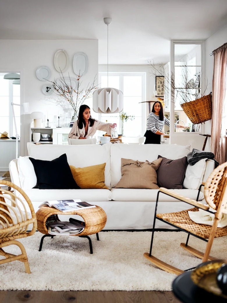 living room area with white couch and rattan seating