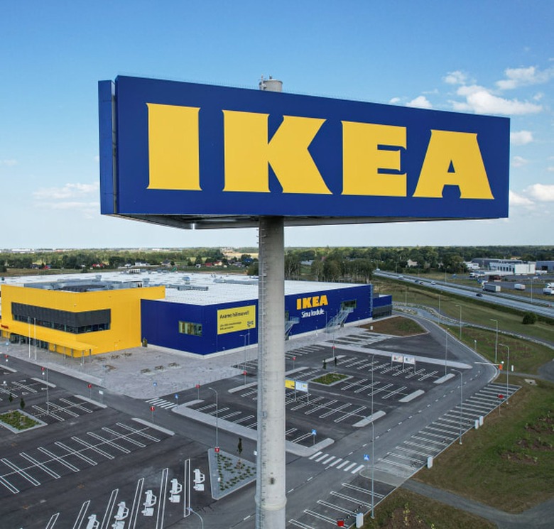 IKEA storefront and logo looking over an empty parking lot in front of a blue sky