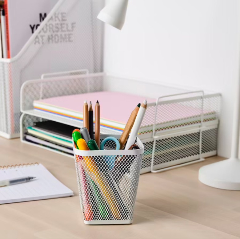 desk with tray and papers and pencil cup with supplies