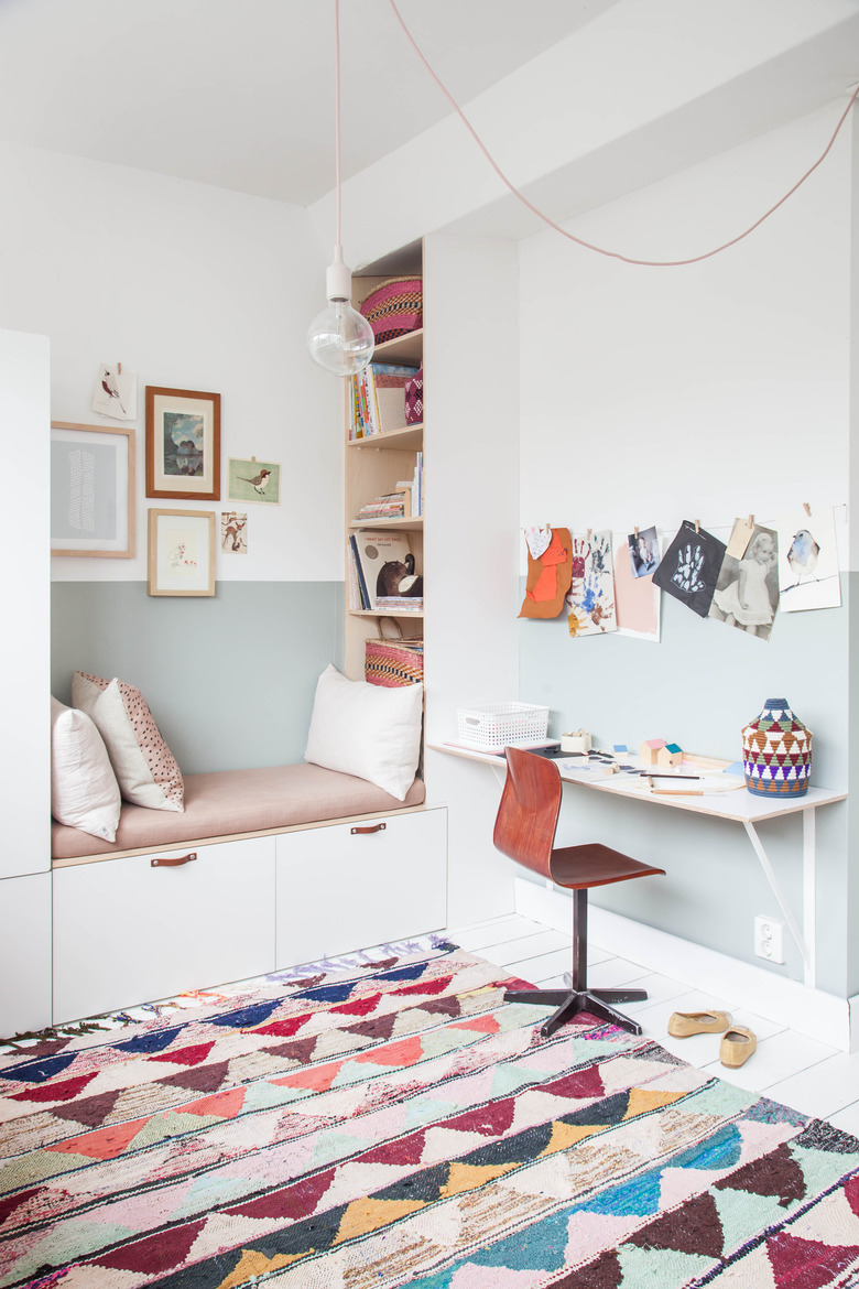 IKEA kids' bedroom idea pink and white reading nook with colorful patterned rug