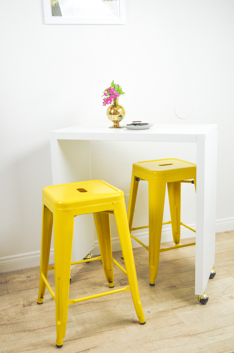 IKEA kitchen island with yellow bar stools in white kitchen