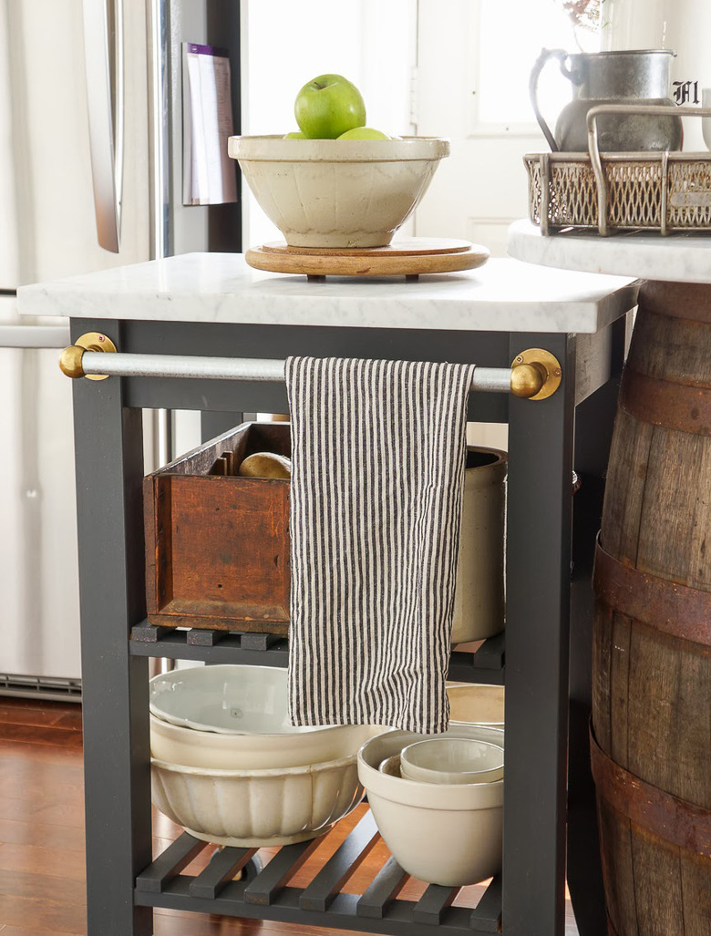 Marble IKEA kitchen island with painted black details and metal towel bar