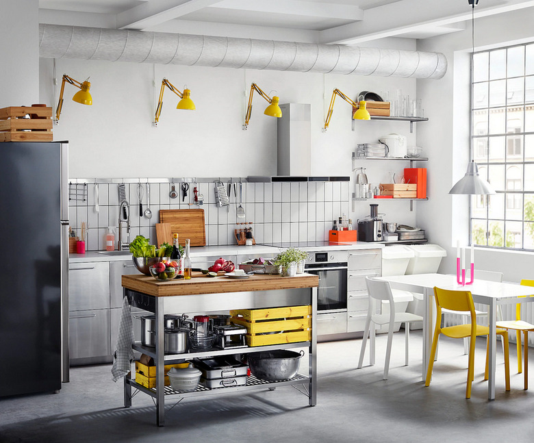 Stainless steel and bamboo IKEA kitchen island in industrial kitchen