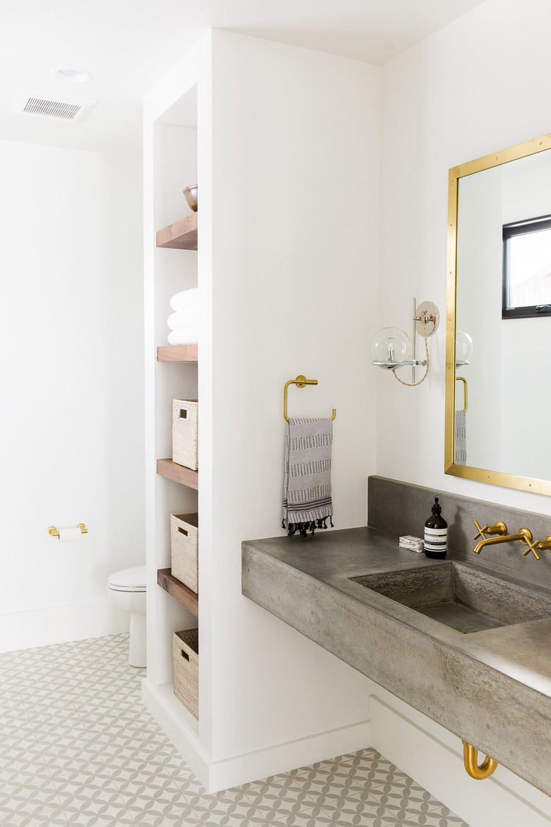 concrete industrial bathroom vanity and brushed gold accents