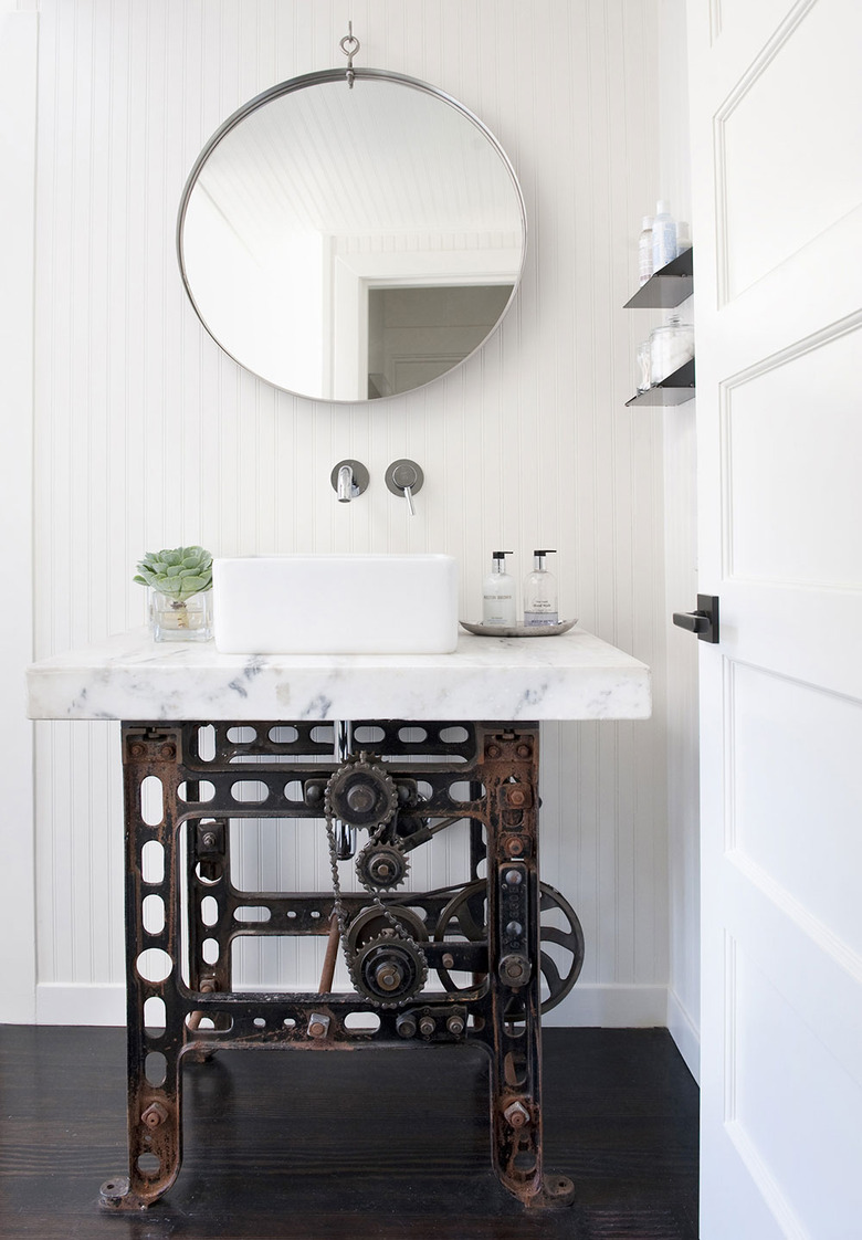 sculptural industrial bathroom vanity with Carrara marble top